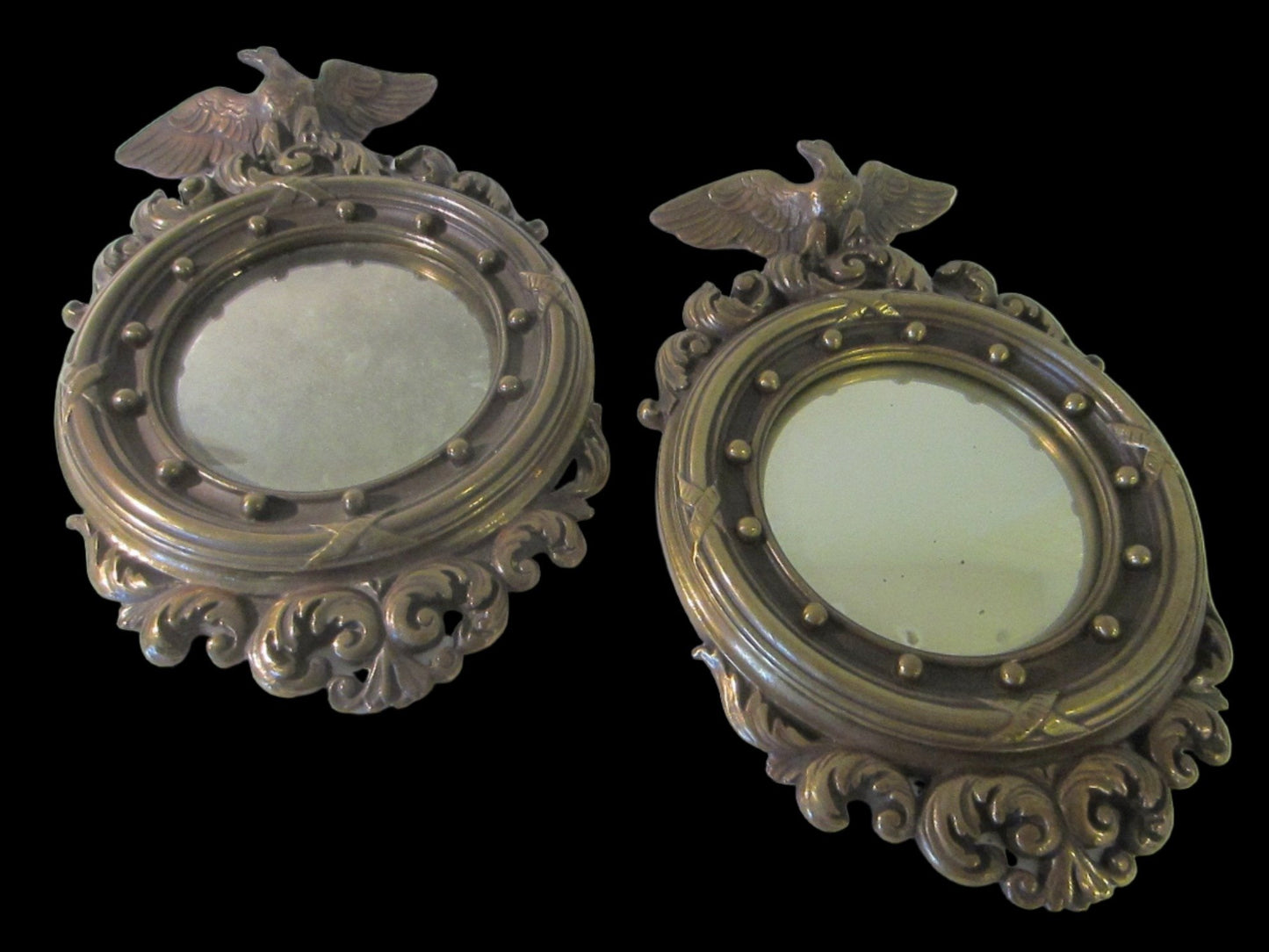 A Pair of Colonial Antiqued Eagle Crest Mid Century Convex Mirrors